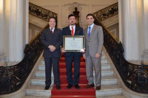 Dr. Florian Kongoli holding the Diploma giving him the title of Honorary Citizen of Rio de Janeiro