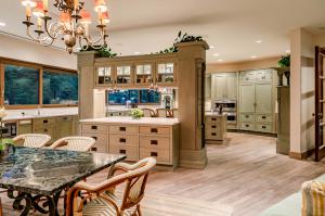 The public spaces occupy two wings, encompassing a large chef's kitchen, two dining rooms, a great room, and a theater.